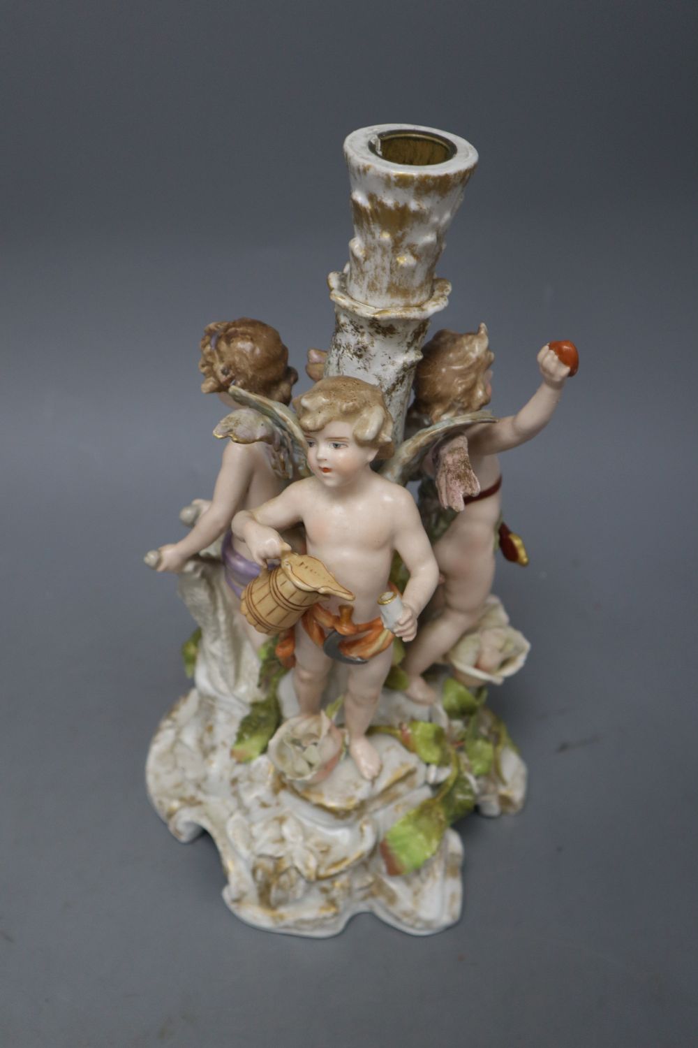 A Sitzendorf floral encrusted porcelain fruit stand, on a figural support, overall height 40cm